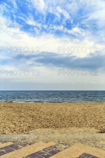 View from the empty sandy beach to the sea and cloudy sky, sunny autumn weather, full format, Wyk