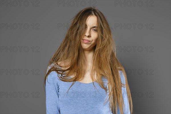 Portrait of annoyed woman with long tangled hair