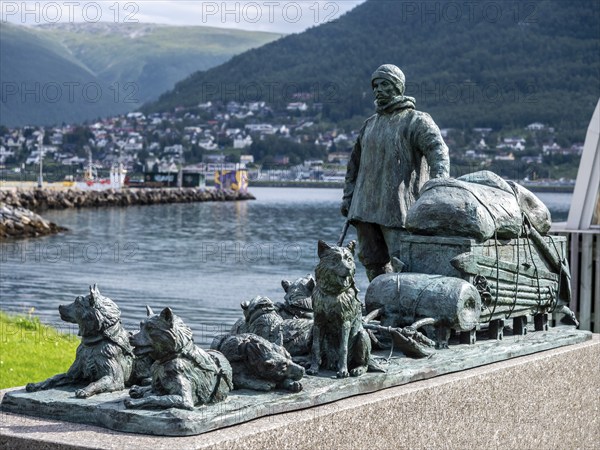 Sculpture of a polar explorer with dog sled, outside museum Polaria, Tromsø, Norway, Europe