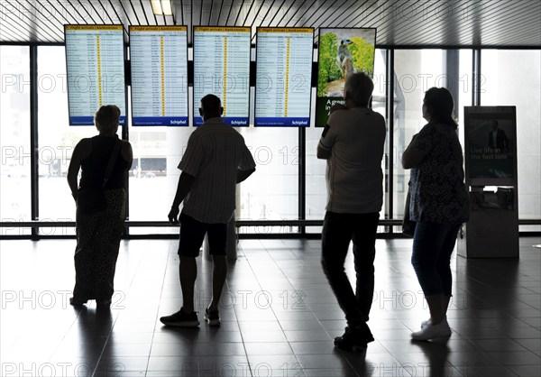 Info screens for departures, arrivals at Amsterdam Schiphol Airport, Terminal, Netherlands