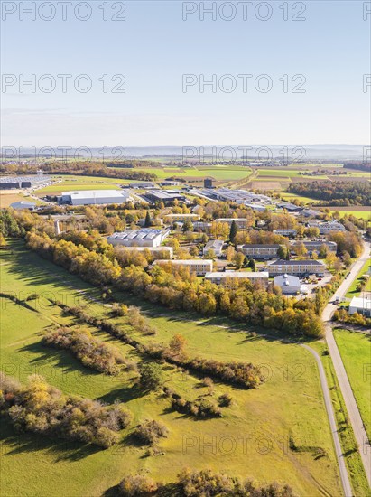 Panoramic view of an industrial area, surrounded by fields and autumnal forest, high ropes course,