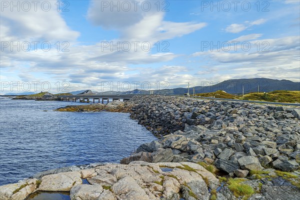 Bridge connecting rocky shores under a cloudy sky, autumn, Atlantic Road, Atlanterhavsveien,