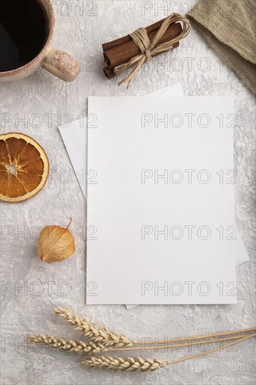 White paper invitation card, mockup with ear of wheat, bun, cup of coffee, linen textile, physalis