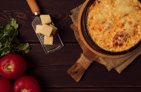 Baked tomatoes with Suluguni cheese, Ketsi in a clay pan, Georgian dish, homemade, top view, on a