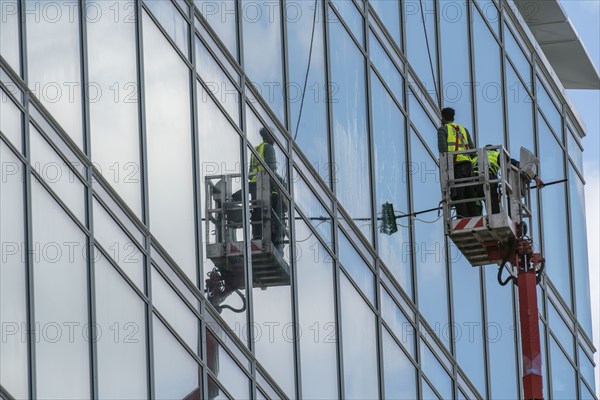 Window cleaner, building maintenance, facade cleaning, on a cherry picker, in Düsseldorf, North