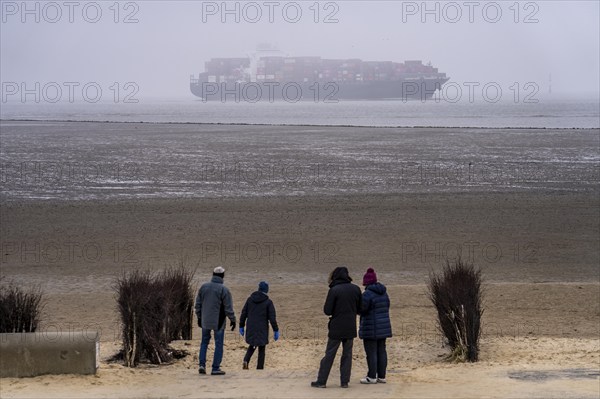 Thick fog in winter, hanging over the mouth of the Elbe into the North Sea, container ship NYK