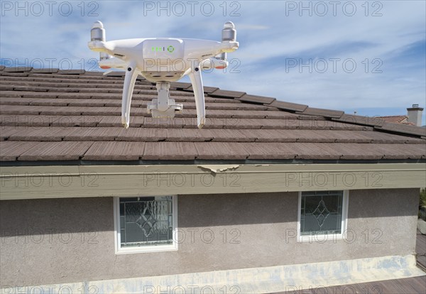 Quadcopter UAV drone flying A residential roof inspection