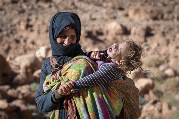 Berber woman, with baby on her back, traditional clothing, Morocco, Africa