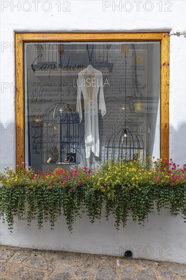 Window of a jewellery shop decorated with flowers in the old town of Eivissa, Ibiza Town, Ibiza,