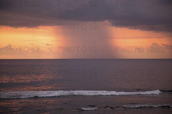 Rainstorm and clouds at sea at sunset viewed from Galle, Sri Lanka, Asia