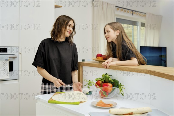 Happy moments of family communication and everyday life. The daughter communicates with her mother