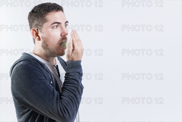 Person with bad breath problem isolated. Man with latisosis checking bad breath