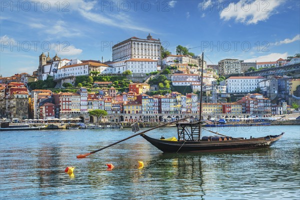 View of Porto city and Douro river with traditional boats with port wine barrels from famous