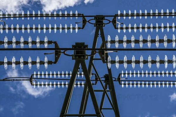Insulators made of glass on a high-voltage line, they hang on the pylons as a suspension device
