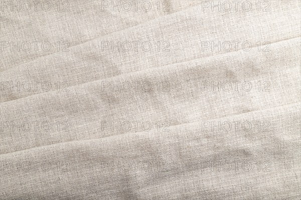 Fragment of white linen tissue. Top view, flat lay, natural textile background and texture. wave