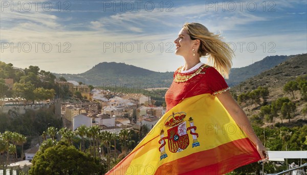 A happy blonde woman holding the flag of Spain, historical town in the background, AI generated, AI