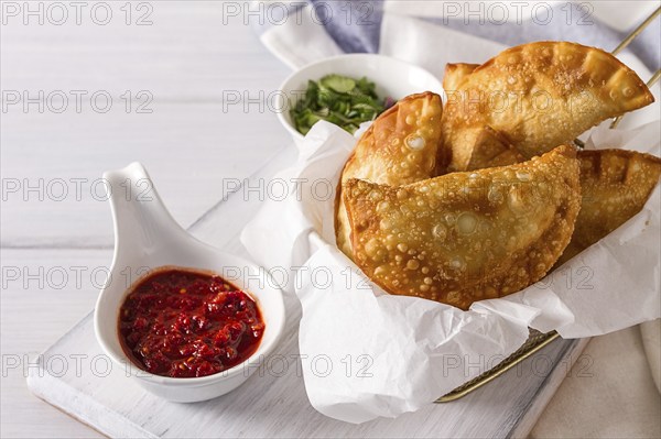 Fried chebureks, close-up, on a white background, no people