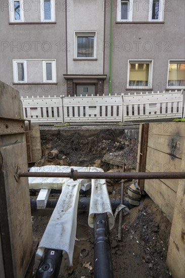 Construction site of a district heating house connection, pipes, insulated, are laid from a central