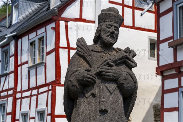 Monreal, idyllic half-timbered village in the Elz valley, figure of Nepomuk, the bridge saint, in