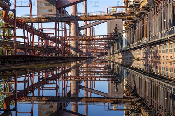 Zollverein coking plant, coke ovens, chimneys and conveyor bridges are reflected in the water