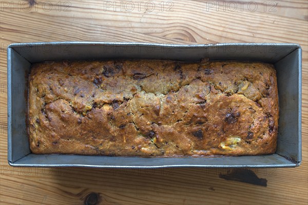 Freshly baked English tea cake with sultanas in a baking tin, Bavaria, Germany, Europe