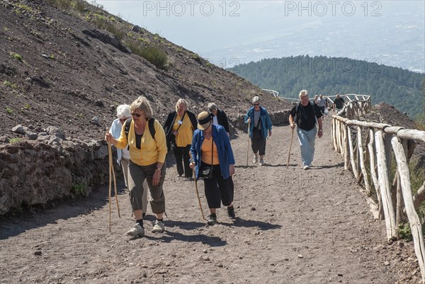 Tourists walking on a path to Vesuvius, near Naples, Parco Nazionale del Vesuvio, Campania, Italy,