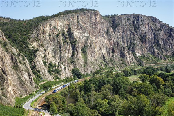 The Rotenfels with an Alstom Coradia LINT regional train operated by Vlexx in Traisen, Germany,