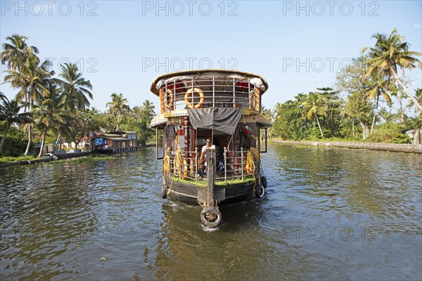 Traditional houseboat on a canal in the canal system of the backwaters, Kerala, India, Asia