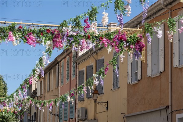Colourful garlands of flowers hang in the streets of Sainte-Maxime, Provence-Alpes-Côte d'Azur,