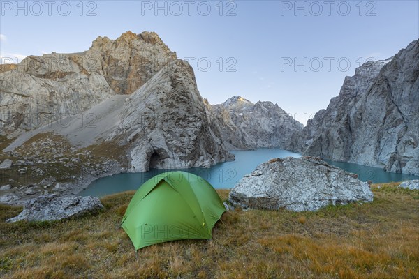 Wild camping, camping in the wilderness with a tent in front of mountain lake Kol Suu, Sary Beles