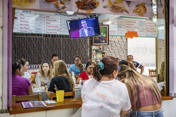 Visitors sitting at a food stall at the counter, Mercado Central de San José, San José, Costa Rica,