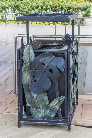 Metal trash can with forging a leaf