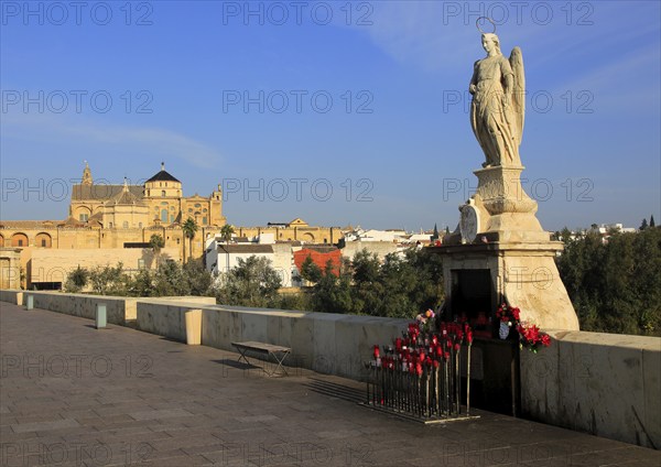 Angel San Rafael statue on Roman bridge with views cathedral, Cordoba, Spain, Europe