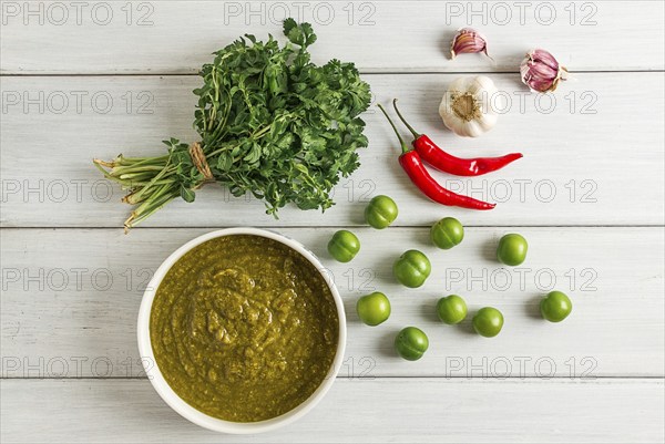 Tkemali sauce, traditional Georgian cuisine, green cherry plum, with ingredients for sauce,