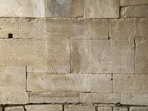 Detailed view of sandstone blocks Stones made of sandstone with written laws carved into the wall
