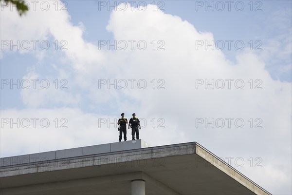 Two police officers observe the citizens' festival Celebrating democracy. / The Basic Law turns 75,