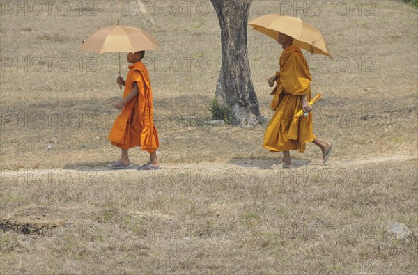 Novice and monk with parasol, Cambodia, Asia