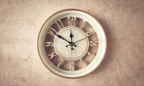 Mechanical wall clock, transparent, beige color, on a light painted wall, rustic style, vintage, no