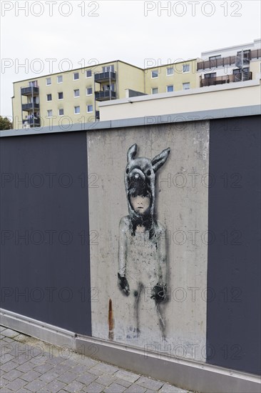 Little girl with animal cap, only surviving mural on a freshly painted wall, by street artist L.E