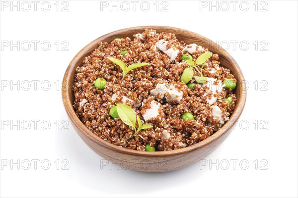 Quinoa porridge with green pea and chicken in wooden bowl isolated on a white background. Side
