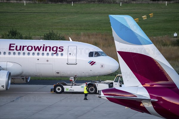 Eurowings aircraft on the apron, being cleared for take-off and pushed from the terminal,