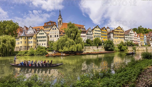Neckarfront Tübingen with punt on the Neckar. Postcard motif with historic buildings, collegiate