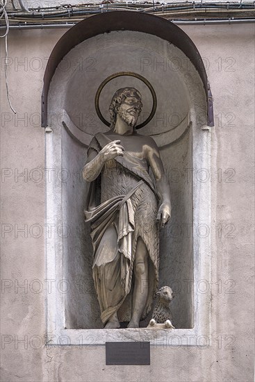 Sculpture of Juesu with the lamb, in a niche on the façade of a residential building, Genoa, Italy,