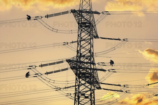 Overhead line fitters working on a high-voltage pylon, overhead lines, energy, worker, high-voltage