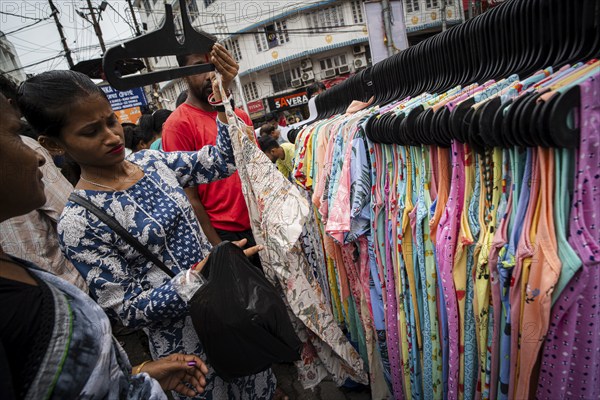 People buys clothes at a street market ahead of Durga Puja festival on October 7, 2024 in Guwahati,