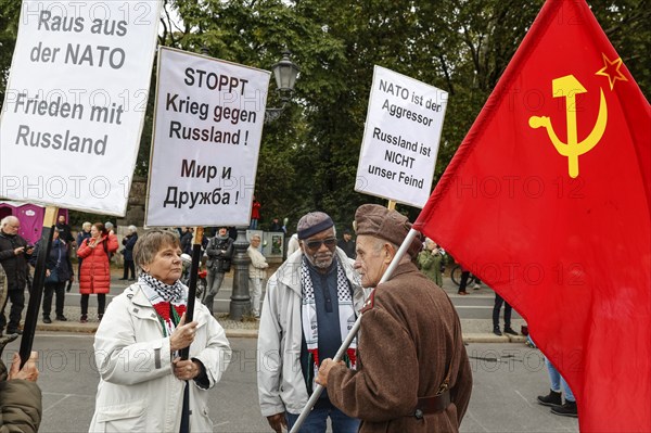 Demonstrators hold placards with slogans such as Stop war against Russia, Get out of Nato, Nato is