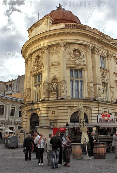 Bucharest, city centre, building in the old town and in front of it a sausage stand, Romania,