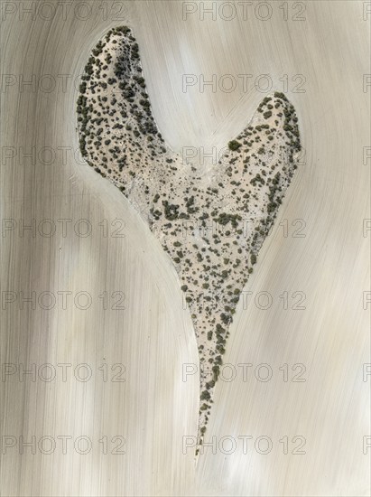 Farmland surrounds a rocky outcrop in the shape of a heart. Aerial view. Drone shot. Granada