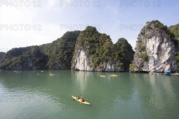 Kayakers and the karst rocks in Lan Ha Bay, Halong Bay, Vietnam, Asia