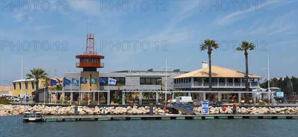 Harbour view with buildings and palm trees on a sunny day, Vilamoura, Faro, Algarve, Portugal,